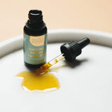 Bottle of Mohi Skin Care bakuchiol face oil on white dish.